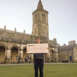 St Andrews Uni fundraiser holding cheque