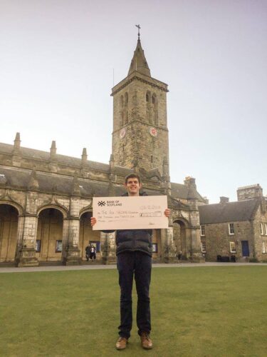 St Andrews Uni fundraiser holding cheque