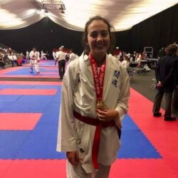 Rebecca wearing her two Karate medals