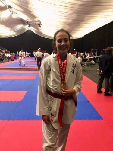 Rebecca wearing her two Karate medals