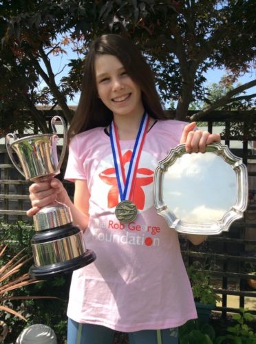 Heaven with her swimming trophies and medals