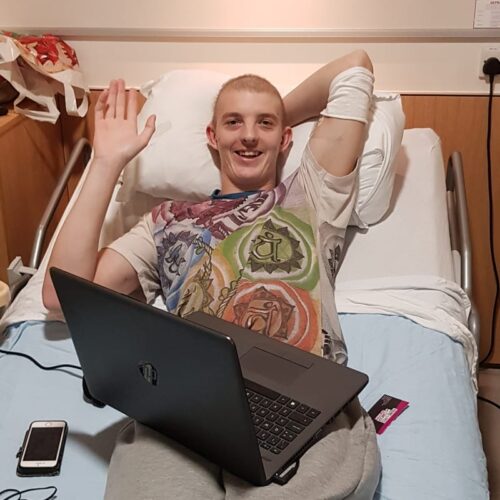 Tom in bed with his new laptop