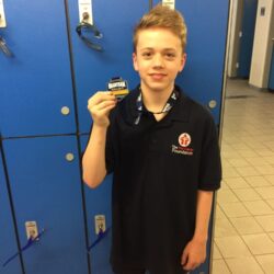 Harry holding his swimming Medal